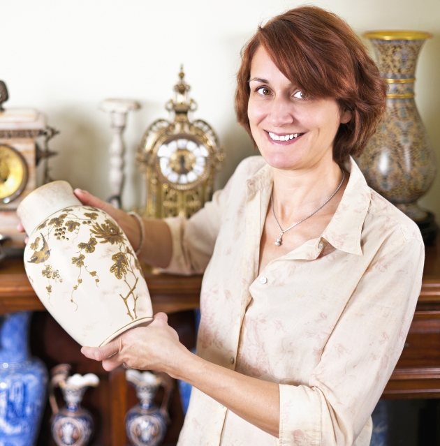 woman carrying a beautiful antique vas in Estate Sales