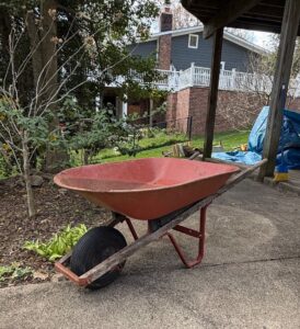 Vintage-Red-Metal-Wheelbarrow-with-Wooden-Handles