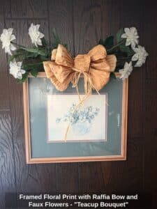 Framed-Floral-Print-with-Raffia-Bow-and-Faux-Flowers-Teacup-Bouquet