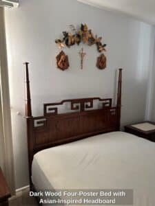 Dark-Wood-Four-Poster-Bed-with-Asian-Inspired-Headboard