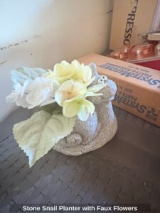 Stone-Snail-Planter-with-Faux-Flowers-1