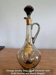 Vintage-Smoky-Grey-Glass-Decanter-with-Gold-Overlay-and-Black-Stopper