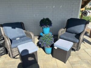Wicker-Patio-Chairs-with-Ottomans-and-Faux-Plants