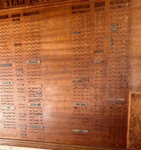 Museum-Quality Fort Worth Star-Telegram Chapel Slug Board An extraordinary original Fort Worth Star-Telegram Chapel Slug Board, measuring an impressive 4' x 8', used in the newspaper's composing room to organize printers, operators, machinists, proof room staff, and other production departments. This handcrafted hardwood board features carved lettering, original department nameplates, hundreds of brass hooks, and the original framed "Rules & Regulations – Star-Telegram Chapel Mutual Aid Society." A rare surviving piece of Fort Worth and newspaper history, this would make an incredible focal point in a home, restaurant, brewery, office, library, museum, or commercial space.