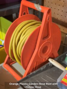 Orange-Plastic-Garden-Hose-Reel-with-Yellow-Hose