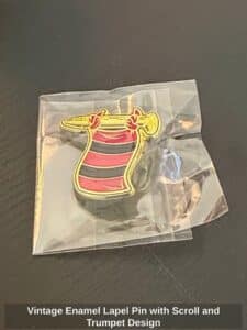 Vintage-Enamel-Lapel-Pin-with-Scroll-and-Trumpet-Design