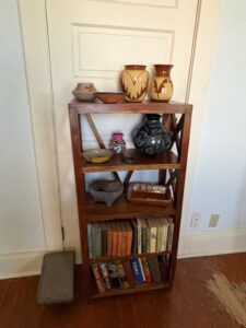 Rustic-X-Frame-Bookshelf-with-Southwestern-Pottery-Collection