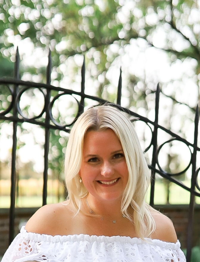 IMG_6835 The photograph is taken outside with Deanna infront of a garden gate. She is smiling, wearing a white blouse and has blond hair. Deanna P. a BMES-Indy team member