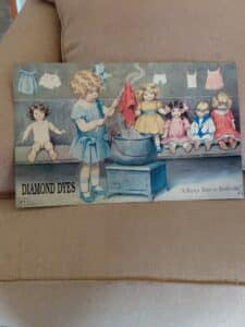 Diamond-Dyes-A-Busy-Day-in-Dollville-Lithograph