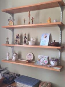 Assorted-religious-decor-collection-on-wooden-shelves