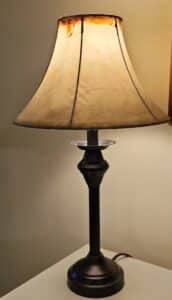 Small-black-metal-desk-lamp-with-parchment-shade