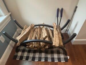 Curved-Metal-Log-Holder-with-Fireplace-Tools-and-Buffalo-Check-Rug