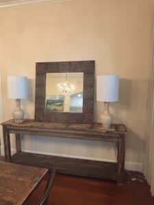 Distressed-Wood-Console-Table-with-Two-Ceramic-Lamps-and-Ornate-Mirror