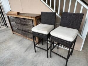 Set-of-Dark-Brown-Wicker-Bar-Stools-with-Off-White-Cushions-and-Distressed-Wood-Console-Table