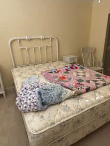 Vintage-White-Metal-Bed-Frame-with-Two-Handmade-Quilts
