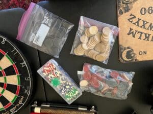 Ceramic-_poker_-chips-in-black-cream-white-red-and-blue-and-box-of-poker-chips