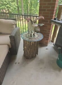Whimsical-Flying-Pig-Sculpture-on-Mosaic-Log-Table