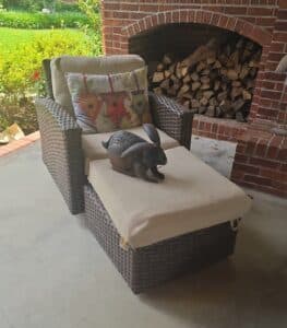Wicker-Patio-Chair-with-Ottoman-and-Decorative-Bunny-Sculpture