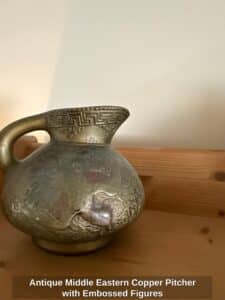 Antique-Middle-Eastern-Copper-Pitcher-with-Embossed-Figures