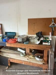 Assorted-Garage-and-Household-Items-on-Wooden-Workbench-1
