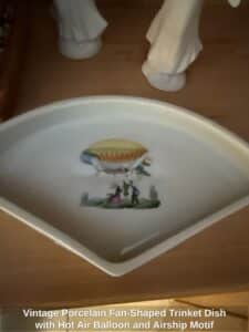 Vintage-Porcelain-Fan-Shaped-Trinket-Dish-with-Hot-Air-Balloon-and-Airship-Motif-second-image
