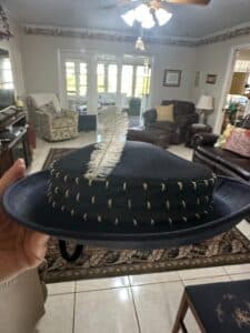 Dark-Blue-Wide-Brimmed-Hat-with-Feather-and-Decorative-Stitching