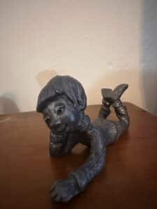 Pewter-Figurine-of-a-Reclining-Child