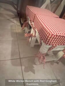 White-Wicker-Bench-with-Red-Gingham-Cushions