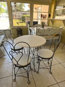 Wrought-Iron-Bistro-Set-with-Heart-Back-Chairs-and-Amber-Glass-Oil-Lamp-second-image