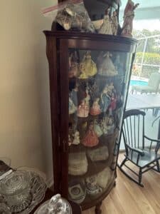 Antique-Oak-Curved-Glass-China-Cabinet-with-Porcelain-Figurines