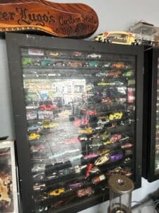Collection-of-Die-Cast-Model-Cars-in-a-Black-Display-Case