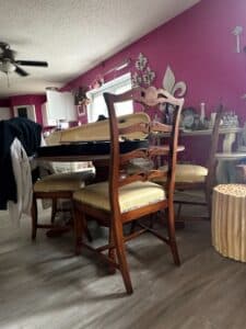 Round-Pedestal-Dining-Table-with-Four-Ladder-Back-Chairs