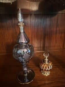 Vintage-Egyptian-Style-Perfume-Bottles-with-Etched-Floral-Design-and-Ornate-Metal-Base