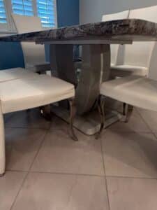 White-Faux-Leather-Dining-Chairs-with-Marble-Effect-Pedestal-Table