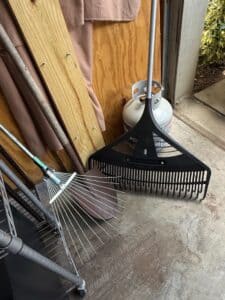 Assorted-Garden-Rakes-and-Propane-Tank