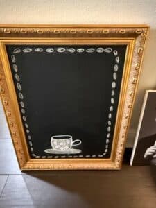 Ornate-Gold-Framed-Chalkboard-with-Teacup-Illustration