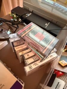 Collection-of-Assorted-Estate-Items-including-American-Family-Scale-Quartz-Clock-Golf-Ball-Coin-Bank-Soviet-Pins-and-Cassette-Tapes-fourth-image