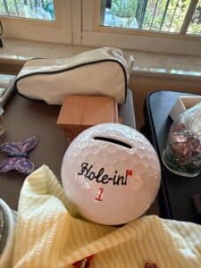 Collection-of-Assorted-Estate-Items-including-American-Family-Scale-Quartz-Clock-Golf-Ball-Coin-Bank-Soviet-Pins-and-Cassette-Tapes-second-image