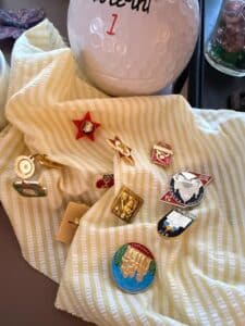 Collection-of-Assorted-Estate-Items-including-American-Family-Scale-Quartz-Clock-Golf-Ball-Coin-Bank-Soviet-Pins-and-Cassette-Tapes-third-image
