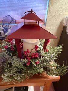 Red-Metal-Lantern-with-Frosted-Greenery-and-Berry-Arrangement