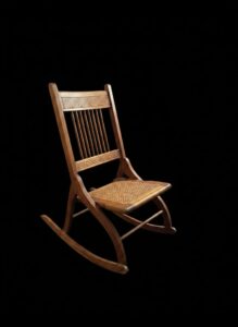 Victorian-Era-Folding-Rocking-Chair-with-Carved-Details-and-Cane-Seat-second-image