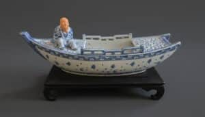 Chinoiserie-Style-Blue-and-White-Ceramic-Boat-Planter-with-Figurine-second-image