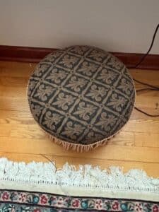 Round-Upholstered-Ottoman-with-Fringe