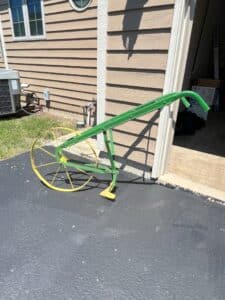 Vintage-Single-Wheel-Plow-or-Cultivator-with-Green-Frame-and-Yellow-Wheel
