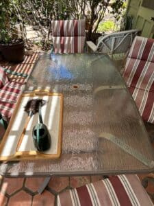 Patio-Dining-Set-with-Glass-Top-Table-and-Striped-Cushioned-Chairs-second-image