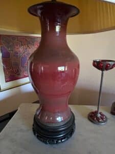 Vintage-Chinese-Oxblood-Glazed-Porcelain-Vase-Lamp-on-Carved-Wooden-Base-second-image