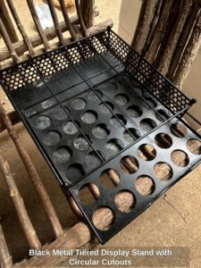 Black-Metal-Tiered-Display-Stand-with-Circular-Cutouts