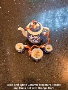 Blue-and-White-Ceramic-Miniature-Teapot-and-Cups-Set-with-Orange-Cord-fourth-image