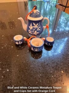 Blue-and-White-Ceramic-Miniature-Teapot-and-Cups-Set-with-Orange-Cord-second-image