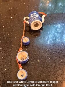 Blue-and-White-Ceramic-Miniature-Teapot-and-Cups-Set-with-Orange-Cord-third-image
